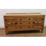 A Derek Lizardman Slater sideboard, having three drawers and two panel cupboard doors with black