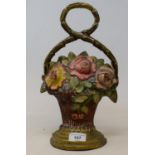 A painted brass doorstop, in the form a of basket of flowers, 33 cm high
