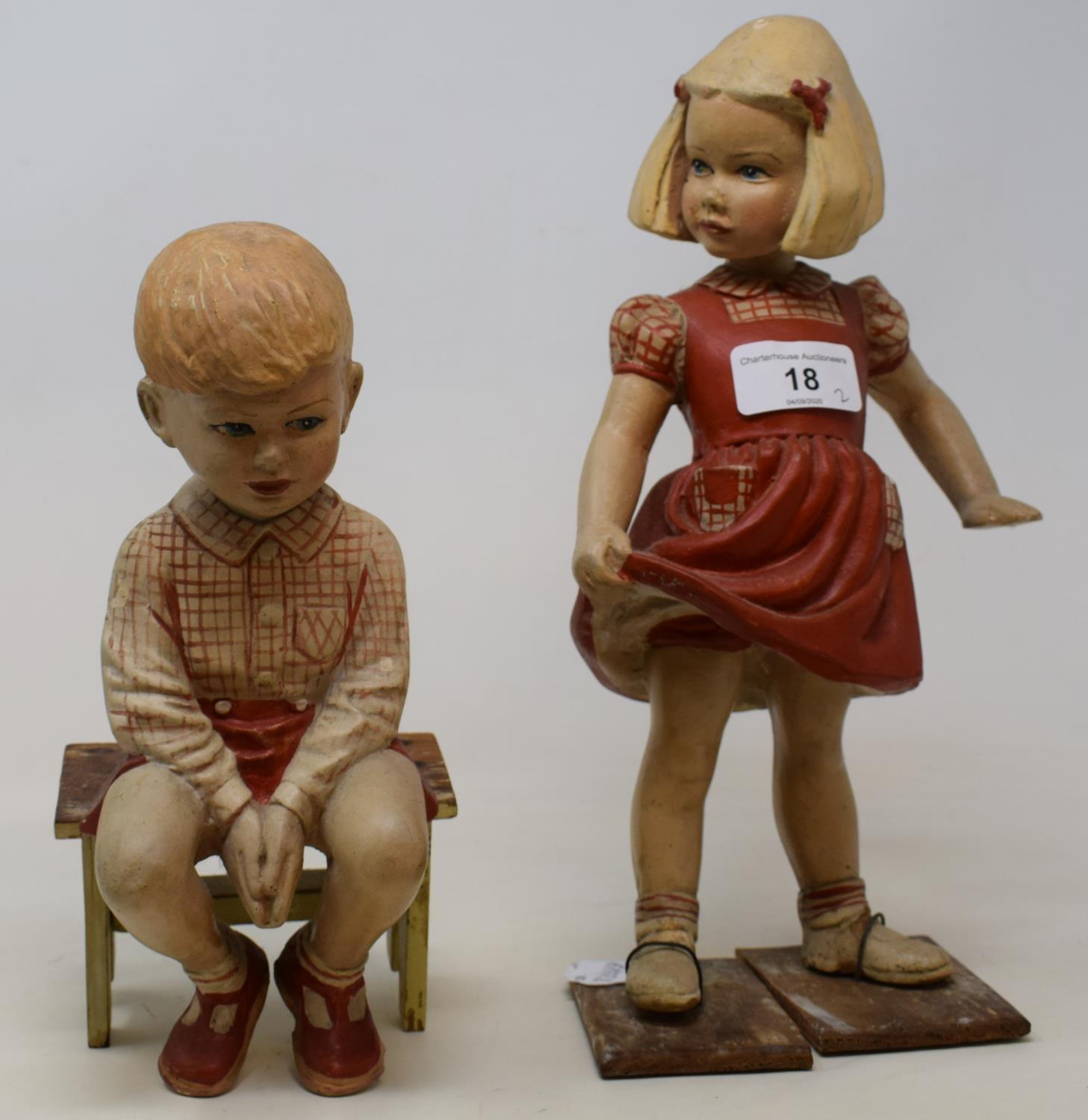 A pair of 1920's plaster figures of a young boy, 20 cm high, and girl, 30 cm high