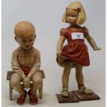 A pair of 1920's plaster figures of a young boy, 20 cm high, and girl, 30 cm high