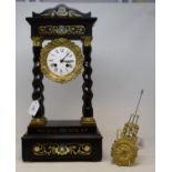 An early 20th century ebonised and gilt metal portico clock, the 10 cm diameter enamel dial with