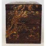An early 20th century Japanese lacquered glove box, tray top above two drawers, decorated with birds
