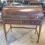 An Edwardian cylinder desk, with a brass three quarter gallery back, a cylinder section and with two