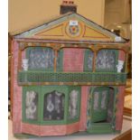 A 1950's painted dolls house, 57 cm wide