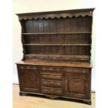 A 18th century style oak dresser,the top with plate rack above five small drawers, base with five