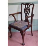 A George III style mahogany carver chair, with a pierced vase shaped splat, a drop in seat and on