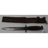 A WWII American M3 combat knife, the 17 cm single edged blade with sharpened back edge point,
