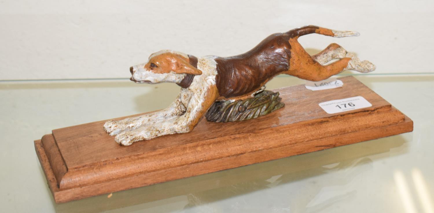 A painted bronze running dog paperclip, on an oak base, 28 cm wide Report by RB Modern