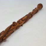 A 19th century one piece folk art walking stick, staff carved with animals, implements, and sporting