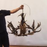 A chandelier, constructed from antlers, 94 cm diameter, and a matching wall light