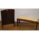 An Arts and Craft style oak stool, 83 cm wide, carved oak firescreen, 50 cm wide (2)