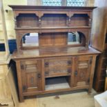 An Arts Crafts style carved oak sideboard, 170 cm wide Report by RB Barn stored, lacks a back leg