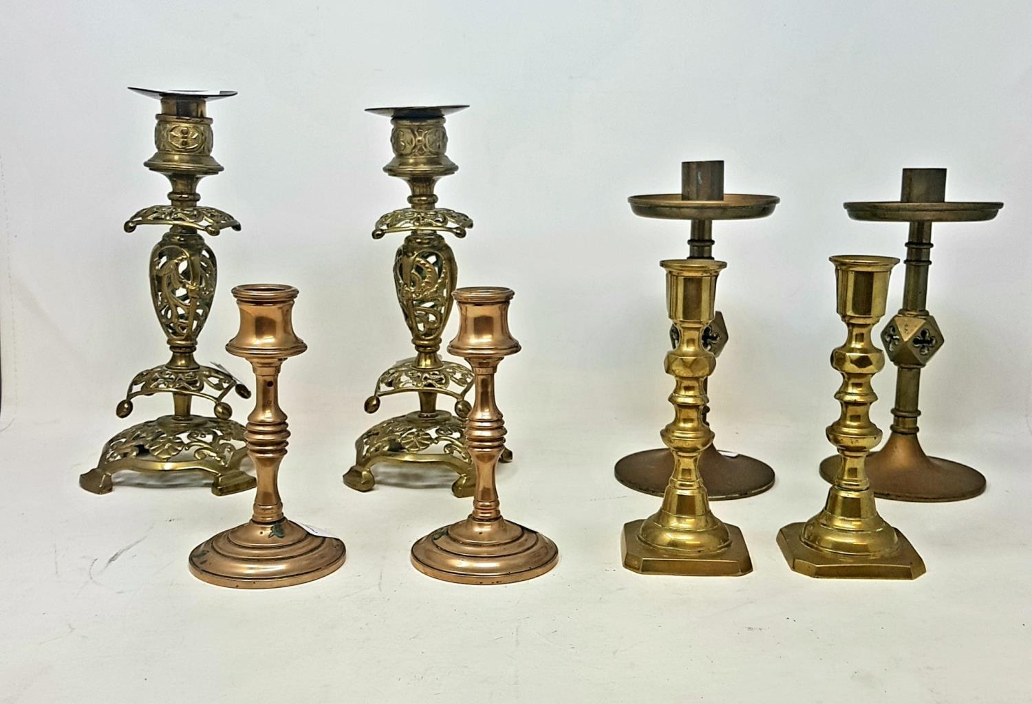 Four pairs of brass candlesticks, tallest 23 cm high