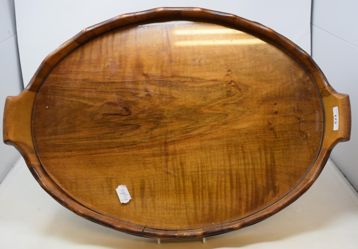 A walnut and brass bound oval tray, 60 cm wide