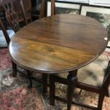 An oval drop leaf table, 106 cm wide, a pair of dining chairs and two mirrors (5)