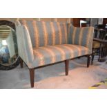 An Edwardian two seater settee, in the George III taste, on tapering square front legs, 122 cm wide