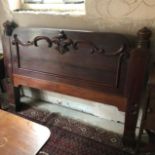 A Victorian mahogany bed end, 153 cm wide, a mahogany Pembroke table, and a mahogany cupboard with a