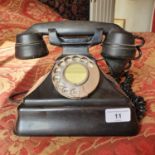 A Bakelite spin dial telephone