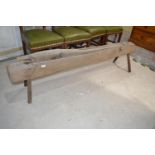 An unusual rustic pig type bench, with a hinged double cutter, 173 cm wide