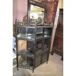 A Victorian Aesthetic period ebonised cabinet, 118 cm wide, lacks a leg, finial loose and present