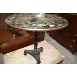 An ebonised tilt top table, with black Chinoiserie style decoration, 60 cm diameter