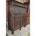 An oak court cupboard, carved figures, grotesque masks and foliage, 1631, 139 cm wide x 173 cm high