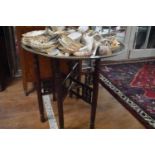 An Indian brass tray, 62 cm diameter, on a folding stand, and assorted shells