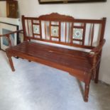 A garden type bench, with a tile inset back, 148 cm wide