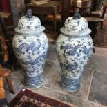 A large pair of Chinese vases and covers, of inverted baluster form, the covers with Dogs of Fo