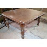 An Edwardian mahogany dining table, on turned legs, 117 cm square, lacks leaves