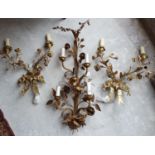 A pair of French style brass floral wall lights, 36 cm wide, and another similar (3)