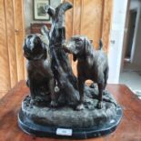 A modern bronze group, of two dogs tied to a tree stumps, on a marble base, 32 cm high