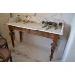 An Edwardian marble top washstand, with two drawers, on tapering fluted legs, 137 cm wide x 96 cm