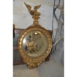 A Regency style gilt convex wall mirror, with an eagle surmount, 102 cm high