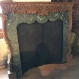 A carved wood fire surround, with a simulated marble inset, 134 cm wide x 118 cm high