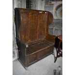 A country made pine wingback box settle, with grained decoration, 113 cm wide x 148 cm high