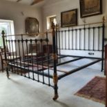 A pair of brass and black painted bed ends, with turned finials, 187 cm wide, with rails