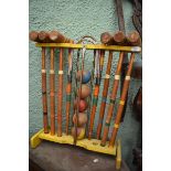 A small garden croquet set, on a stand, 69 cm high overall