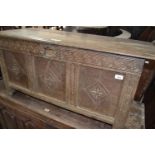 An 18th century carved oak coffer, 121 cm wide