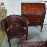 A leather upholstered tub armchair, and a walnut bureau, 76 cm wide