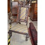 A walnut nursing chair, the back carved a fleurs de lys crest