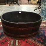 A coopered oak oval bin, 56 cm wide x 23.5 cm high