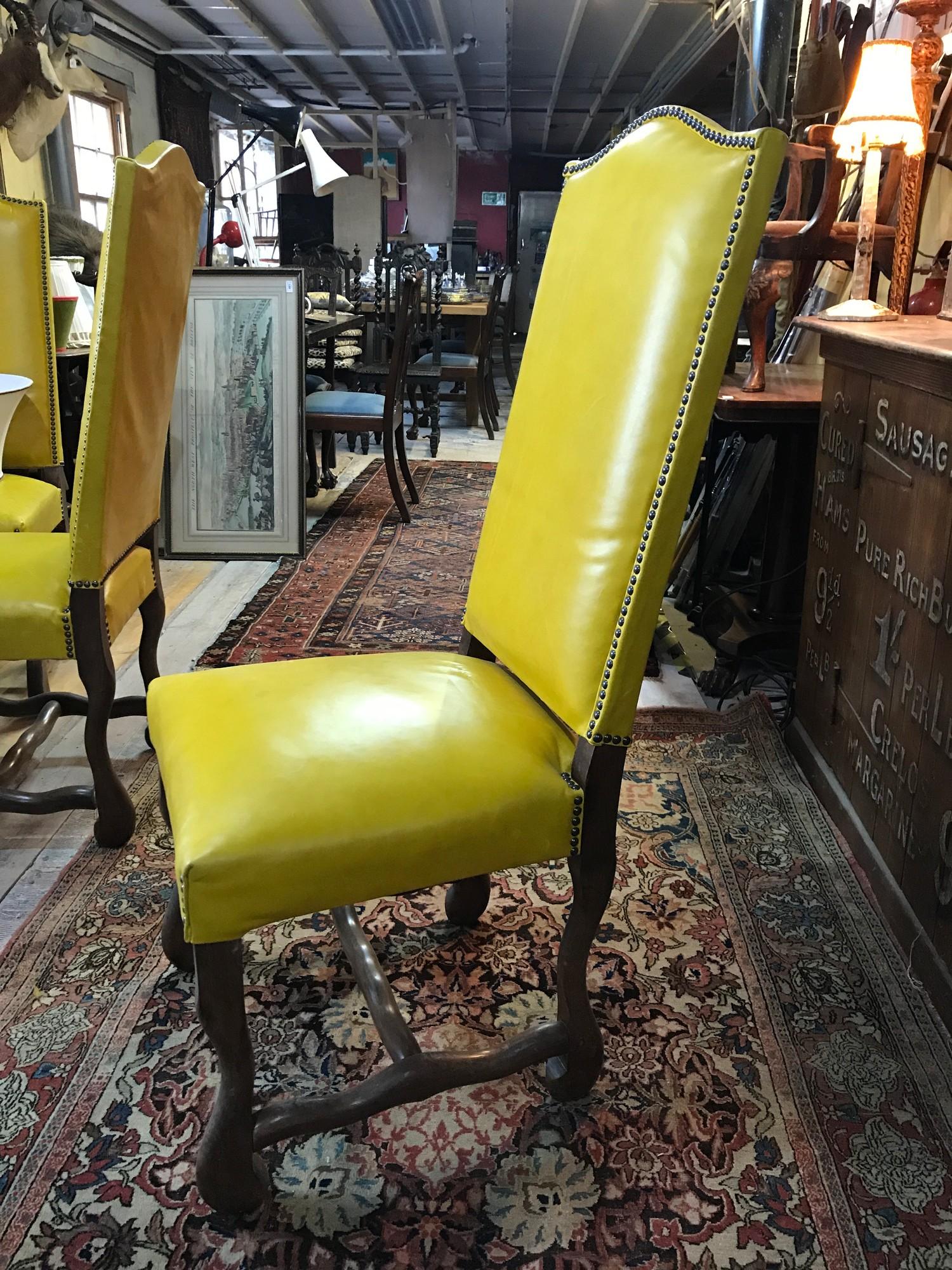 A set of eight dining chairs, upholstered in yellow leather, on shaped legs