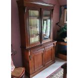 An Edwardian oak bookcase on cupboard, 123 cm wide x 203 cm high