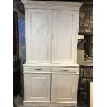 A painted cabinet, having a pair of panel doors, above two drawers and another pair of panel