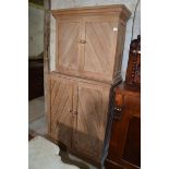 An Edwardian stripped pine cupboard, with two pairs of doors, 86 cm wide