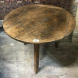 An oak cricket table, repaired, reduced in height, 65 cm diameter x 51.5 cm high