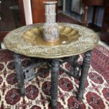 An Indian brass tray, on a folding stand, 77 cm diameter, and a mother of pearl inlaid vase, much