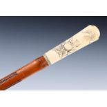 An early 20th century walking stick, with carved ivory handle, carved with Japanese scene with