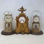 An early 20th century gilt metal perpetual mantel clock, in glass dome and two other clocks (3)